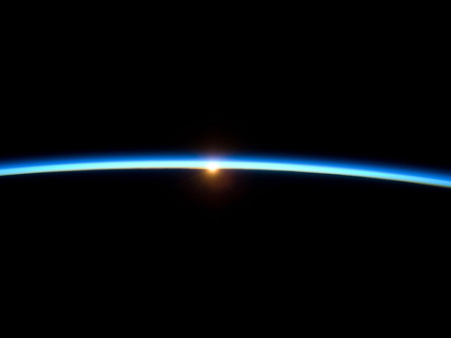 [the Sun setting on the blue line of the Earth’s atmosphere]