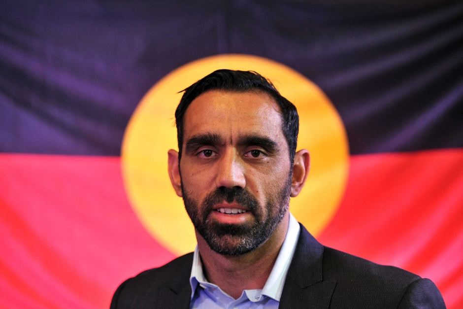 [Adam Goodes with Aboriginal flag as backdrop]